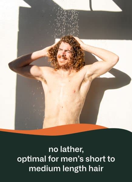 man in shower washing hair